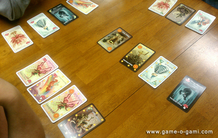 game-o-gami_vgd-04-2012_02 Mid-game, each player has a few Goblins and a few Fairies. The first player to send all of his Goblins to the Fairy Circle (the middle of the table) is the winner!